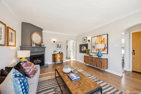 a living room with stainless steel appliances kitchen island granite countertop furniture and a kitchen view