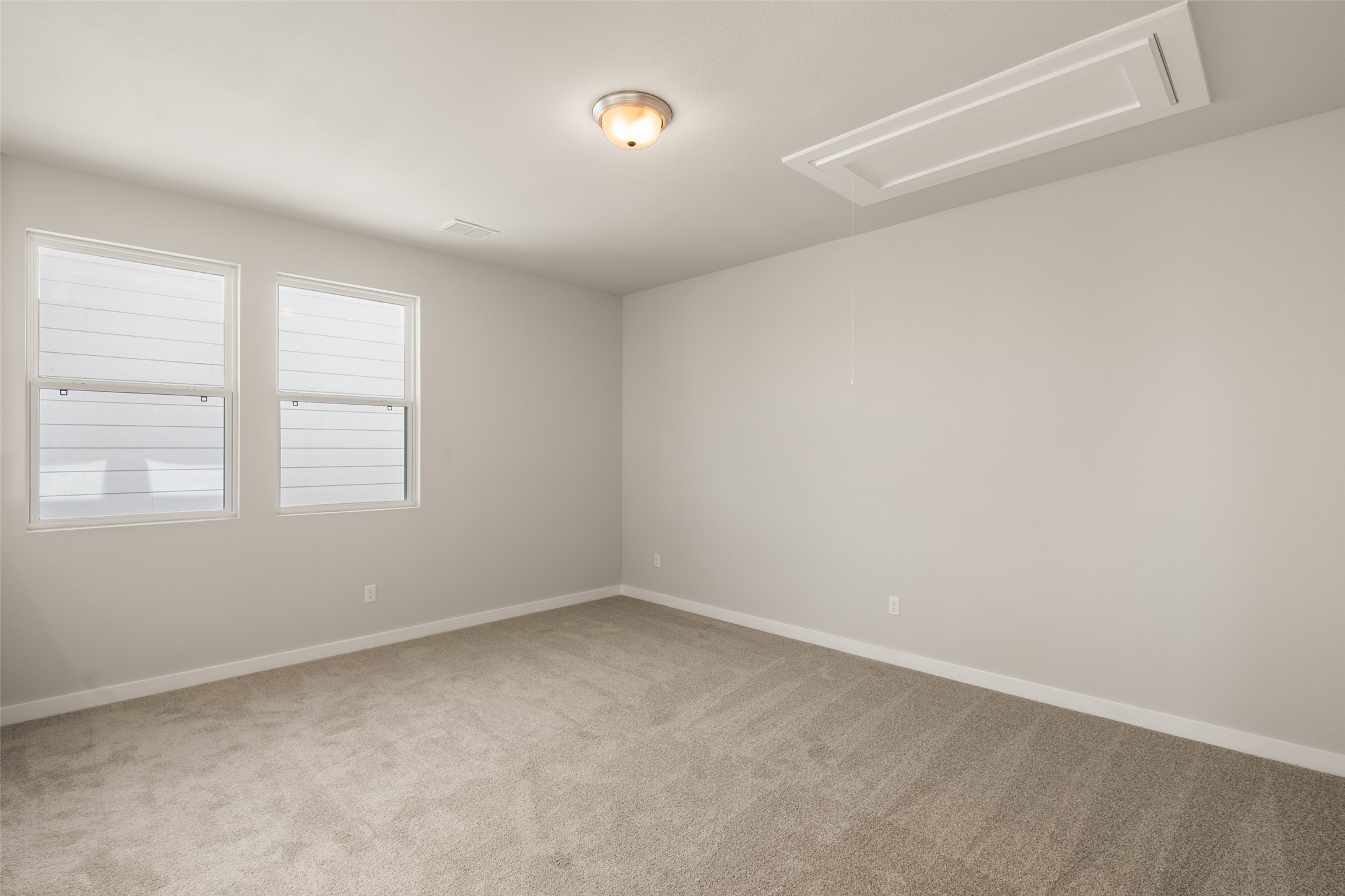 17408 Monastrell Lane Pflugerville, TX 78664 - Photo 13 of 31 Spare room with attic access and light colored carpet