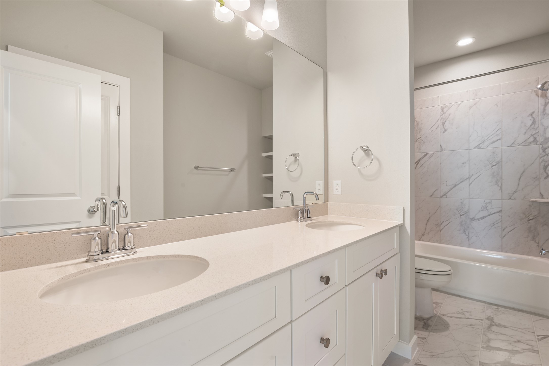 17408 Monastrell Lane Pflugerville, TX 78664 - Photo 17 of 31 Bathroom featuring light marble finish floors, double vanity, and shower / bath combination