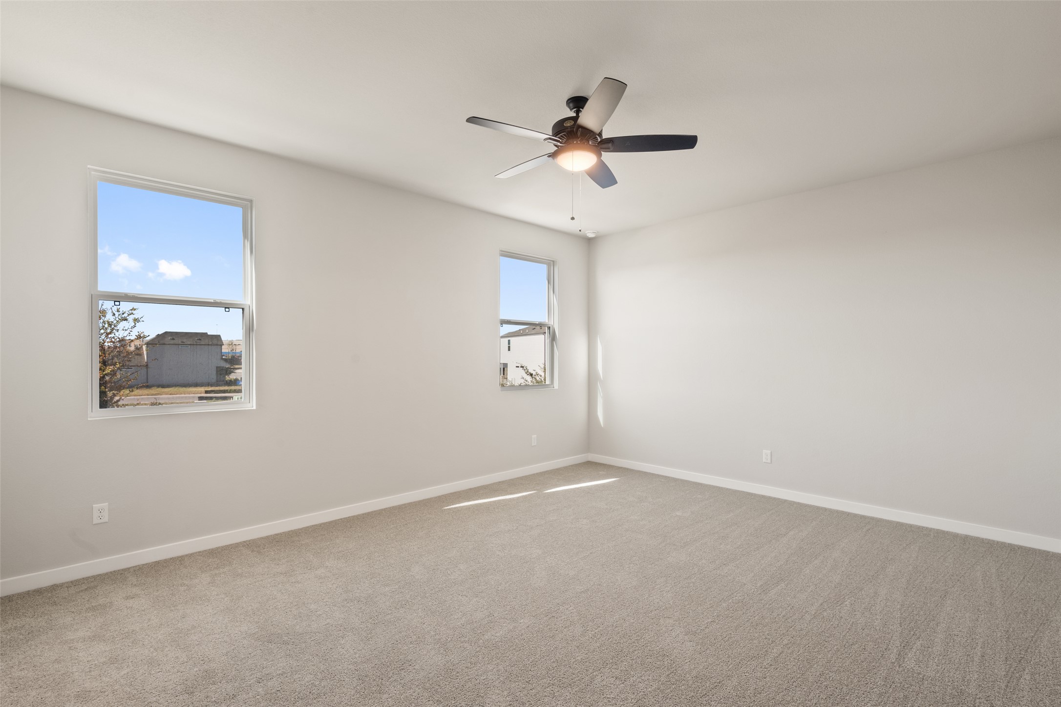 17408 Monastrell Lane Pflugerville, TX 78664 - Photo 18 of 31 Unfurnished room with light colored carpet and ceiling fan