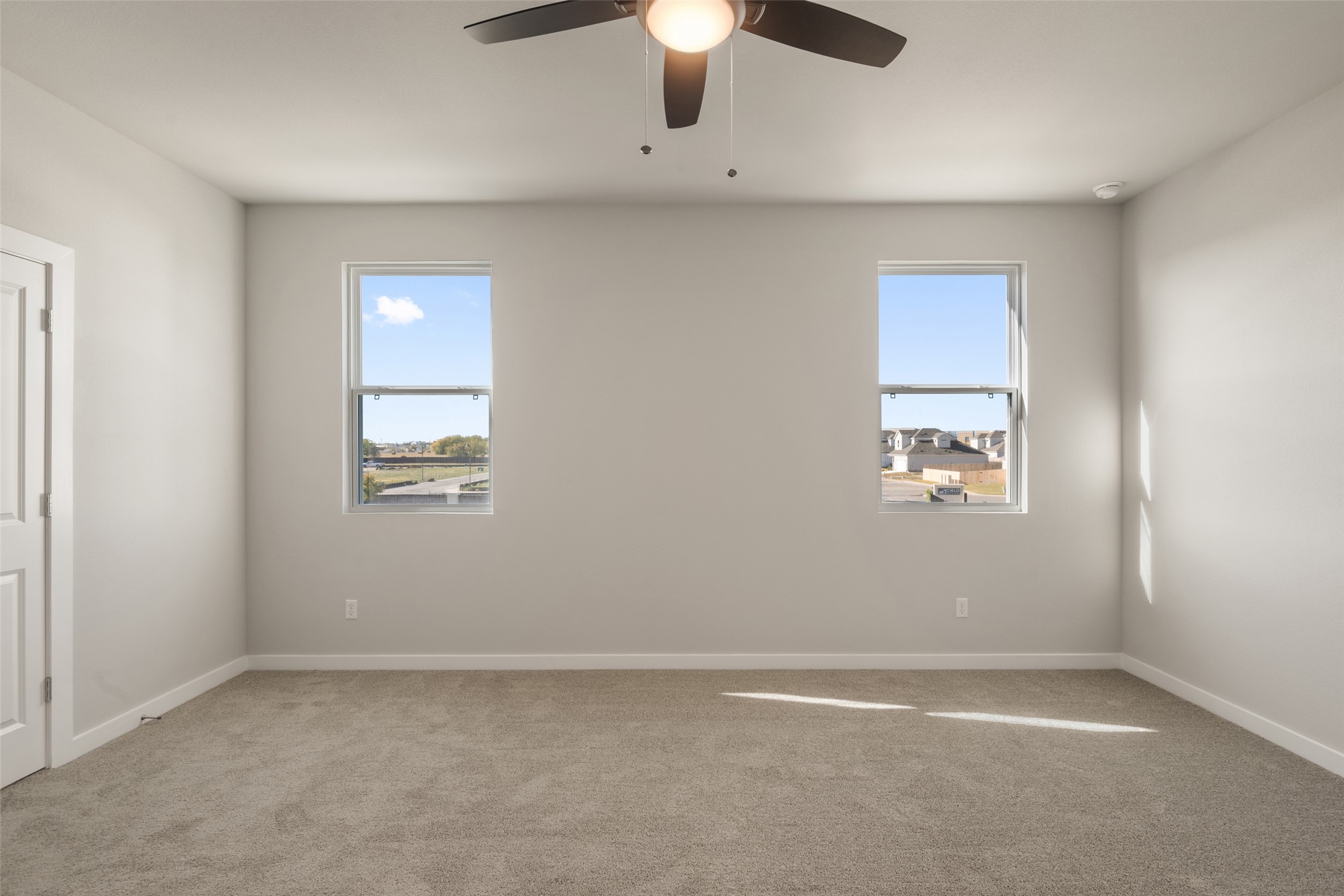 17408 Monastrell Lane Pflugerville, TX 78664 - Photo 19 of 31 Empty room featuring light colored carpet and a ceiling fan