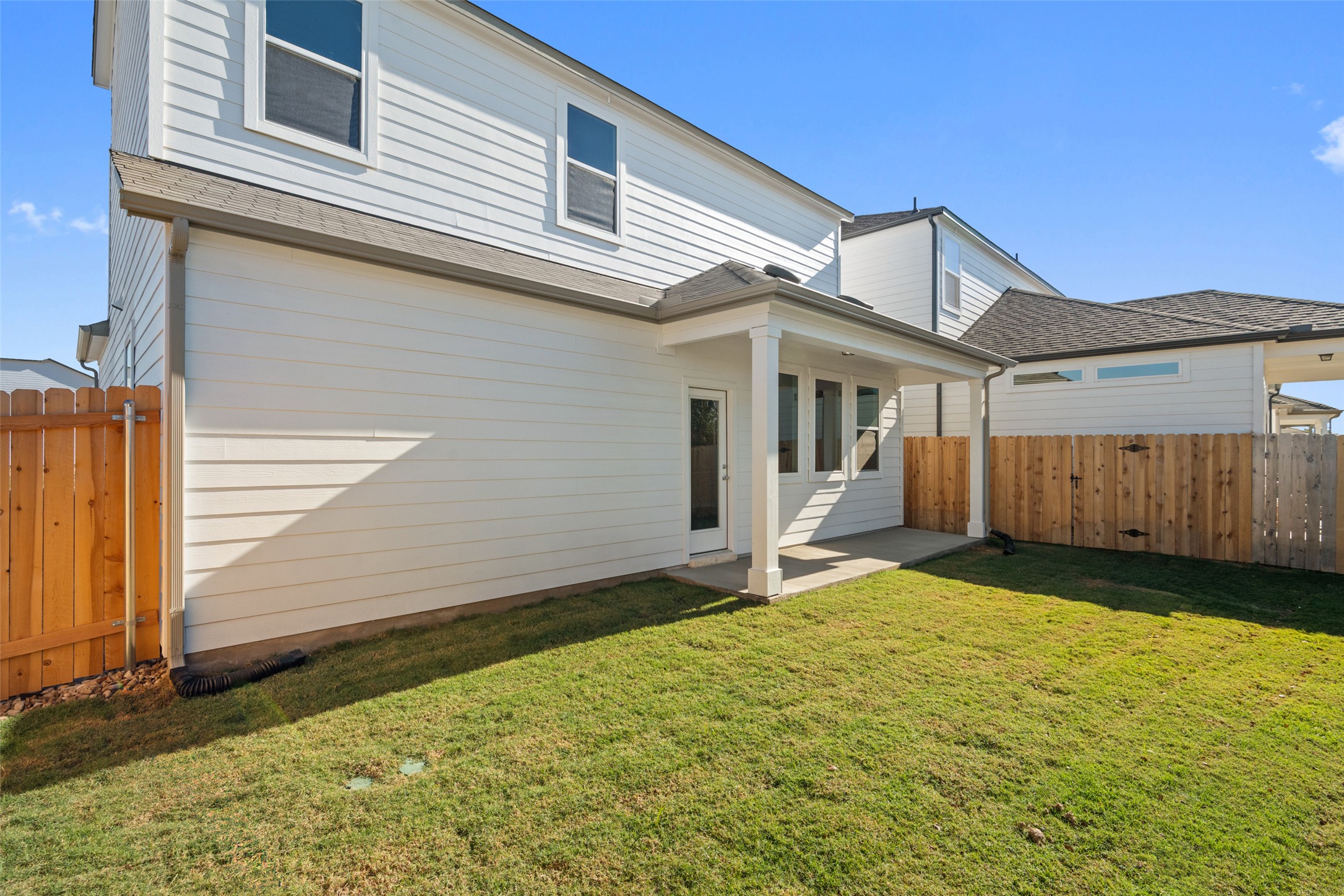 17408 Monastrell Lane Pflugerville, TX 78664 - Photo 26 of 31 Rear view of house featuring a fenced backyard, a patio area, and a shingled roof