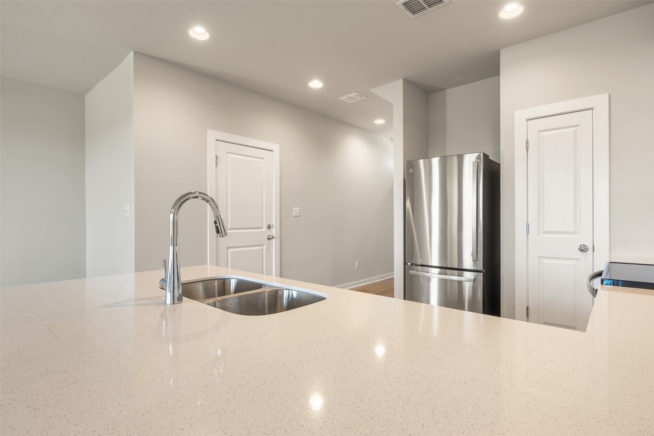 17408 Monastrell Lane Pflugerville, TX 78664 - Photo 5 of 31 Kitchen featuring freestanding refrigerator, recessed lighting, light stone counters, and black electric range