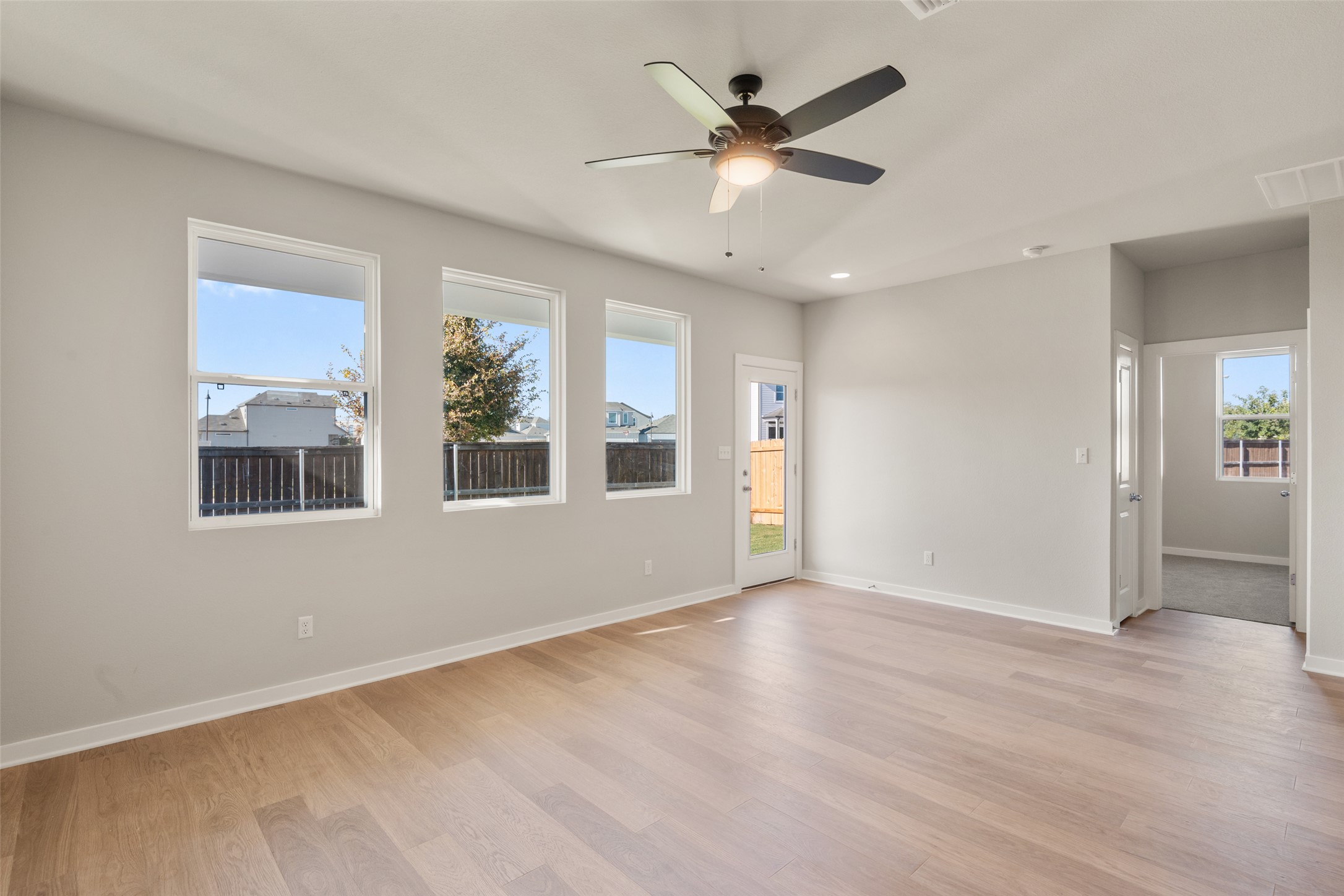 17408 Monastrell Lane Pflugerville, TX 78664 - Photo 9 of 31 Unfurnished room featuring light wood-style floors, a ceiling fan, and recessed lighting