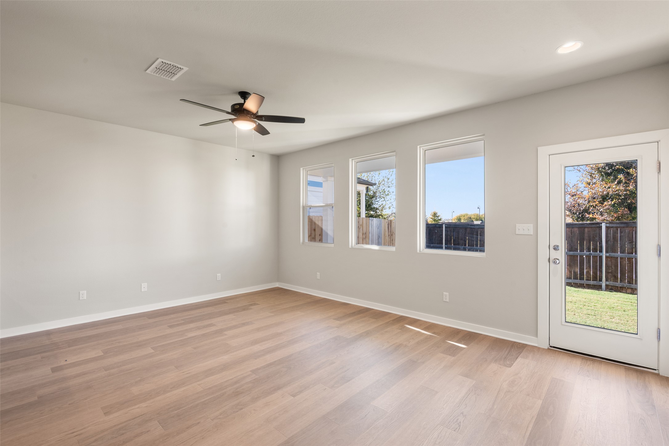 17408 Monastrell Lane Pflugerville, TX 78664 - Photo 10 of 31 Unfurnished room with light wood-type flooring and a ceiling fan