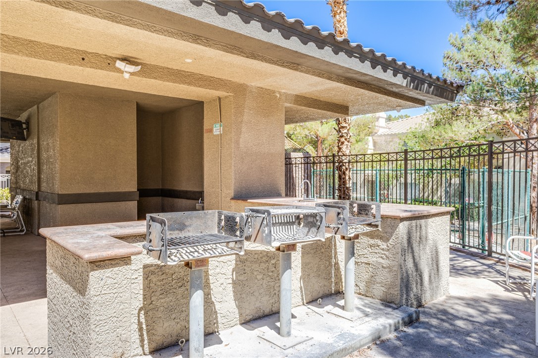 9050 West Warm Springs Road, Unit 1011 Las Vegas, NV 89148 - Photo 27 of 32 An inviting outdoor cooking area with multiple grills, perfect for entertaining.