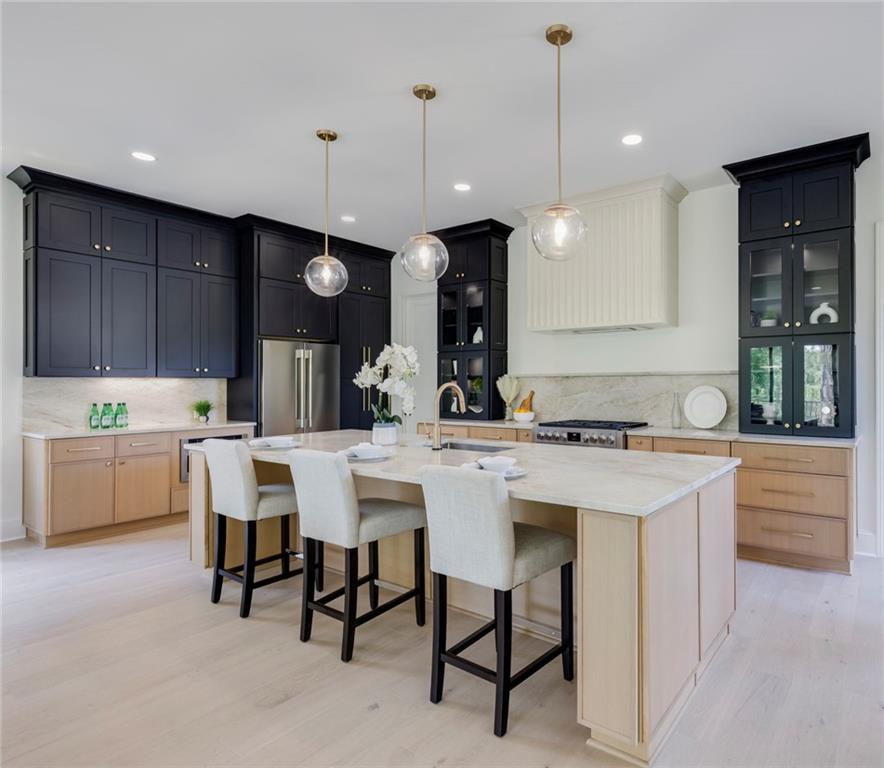 551 Sunset Drive Norcross, GA 30071 - Photo 11 of 45 a kitchen with a sink a counter space appliances and a center island