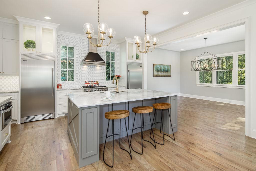 551 Sunset Drive Norcross, GA 30071 - Photo 13 of 45 a kitchen with stainless steel appliances granite countertop a kitchen island hardwood floor and a sink
