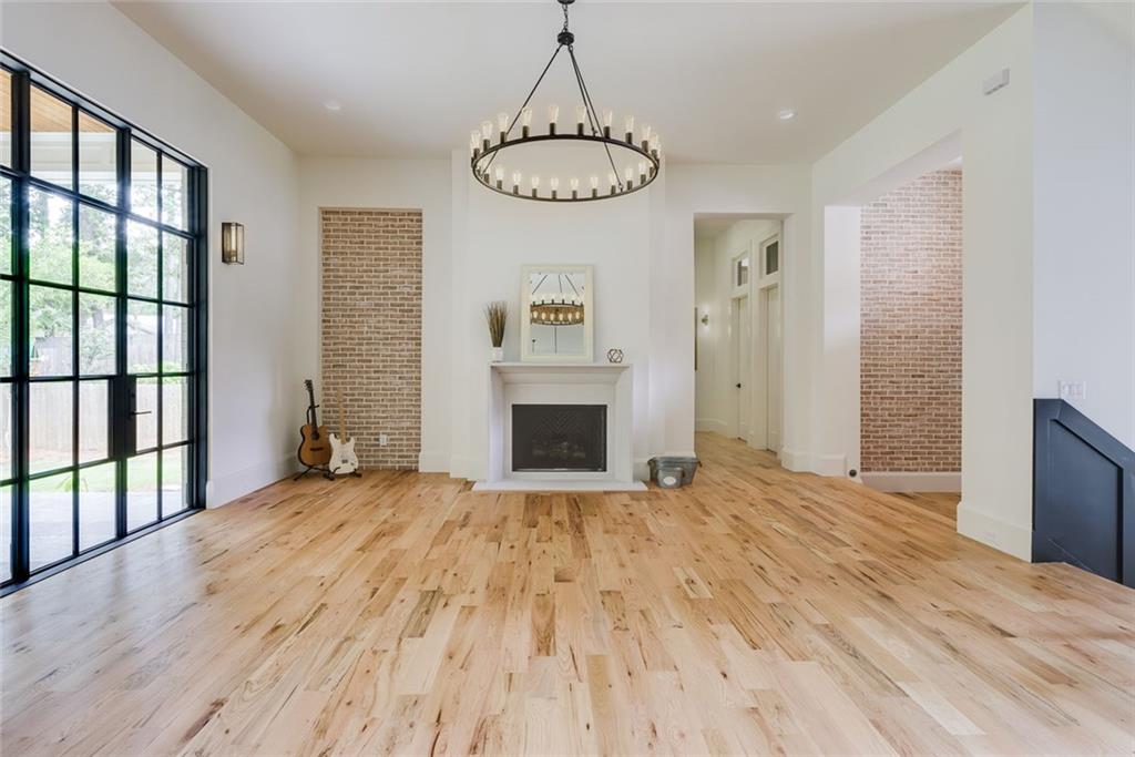 551 Sunset Drive Norcross, GA 30071 - Photo 17 of 45 a view of an empty room with a fireplace and a window