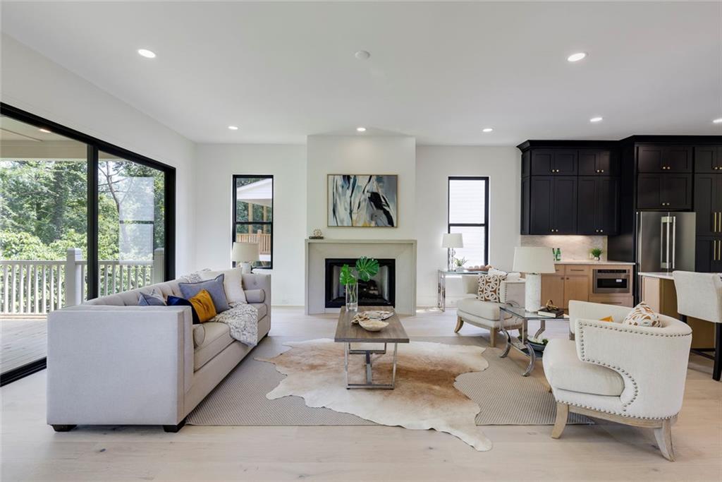 551 Sunset Drive Norcross, GA 30071 - Photo 18 of 45 a living room with fireplace furniture and a large window