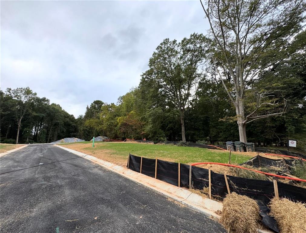 551 Sunset Drive Norcross, GA 30071 - Photo 24 of 45 a view of a swimming pool with lawn chairs under an umbrella