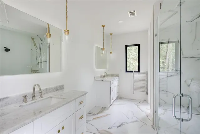 a bathroom with a granite countertop sink mirror and double