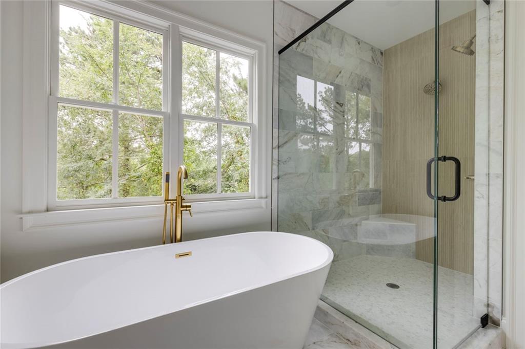 551 Sunset Drive Norcross, GA 30071 - Photo 37 of 45 a bathroom with a tub shower and window