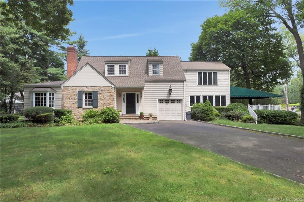 6 Seagate Road Darien, CT 06820 - Photo 1 of 1 a front view of a house with a yard and garage