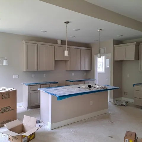 a kitchen with stainless steel appliances granite countertop a sink a stove and a wooden cabinets