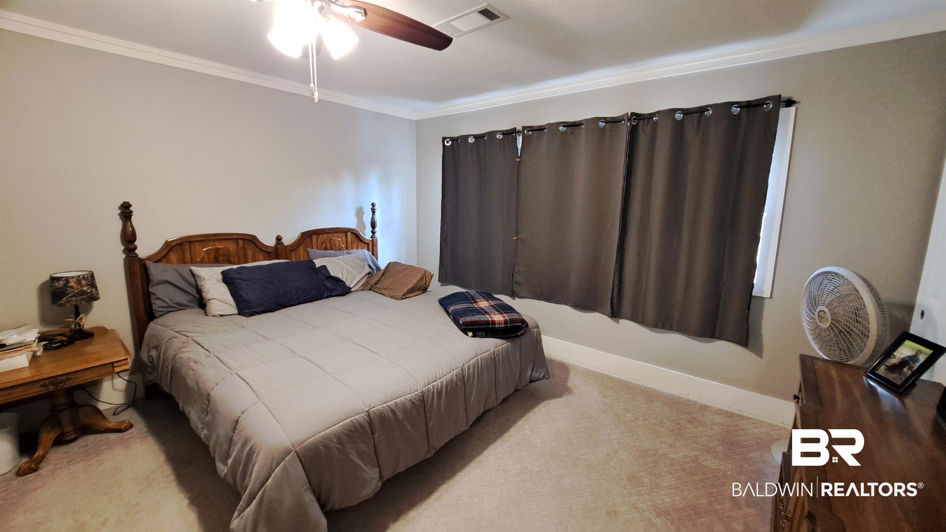 110 South Main Street Evergreen, AL 36401 - Photo 14 of 27 Carpeted room featuring light gray walls, white crown molding, and a ceiling fan with integrated lighting
