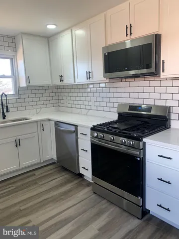 a kitchen with a stove and a microwave