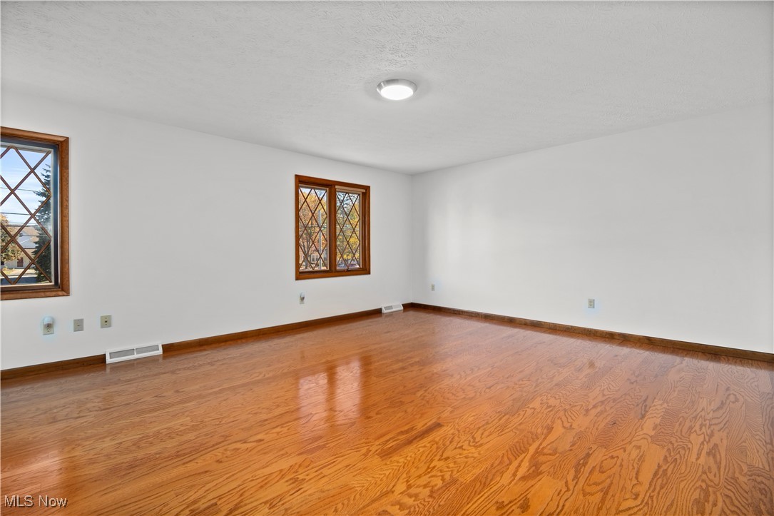 1711 Gulf Road Elyria, OH 44035 - Photo 36 of 50 Empty room featuring light wood-style flooring and a textured ceiling