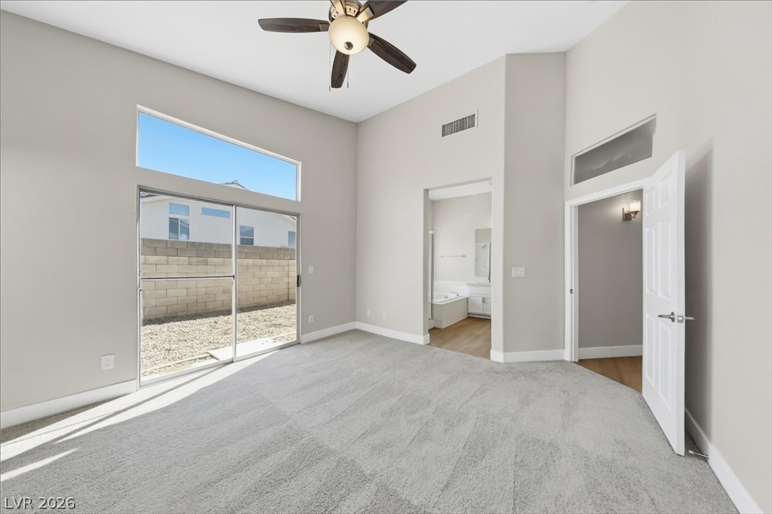 1906 Cardinal Point Street Henderson, NV 89012 - Photo 11 of 20 High ceilings and tall sliding glass doors elevate this comfortable primary suite layout.