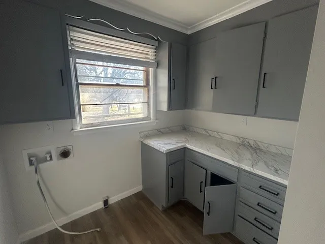 a utility room with cabinets washer and dryer