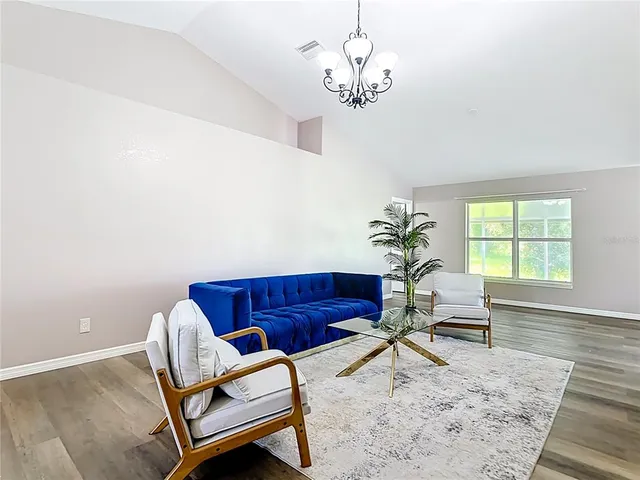 a view of a livingroom with furniture and a chandelier