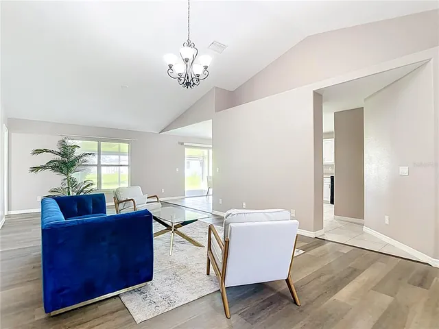 a view of a dining room with furniture and chandelier