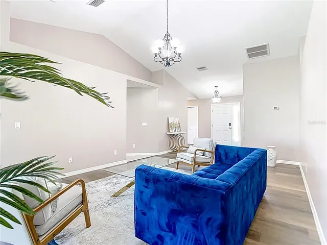a dining room with furniture and chandelier