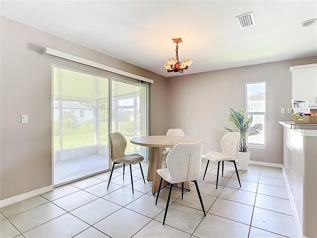 a kitchen with granite countertop white cabinets and a window