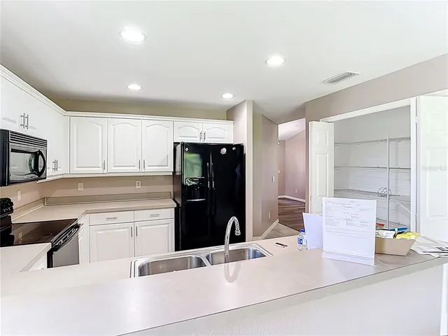 a bathroom with a double vanity sink toilet mirror and bathtub