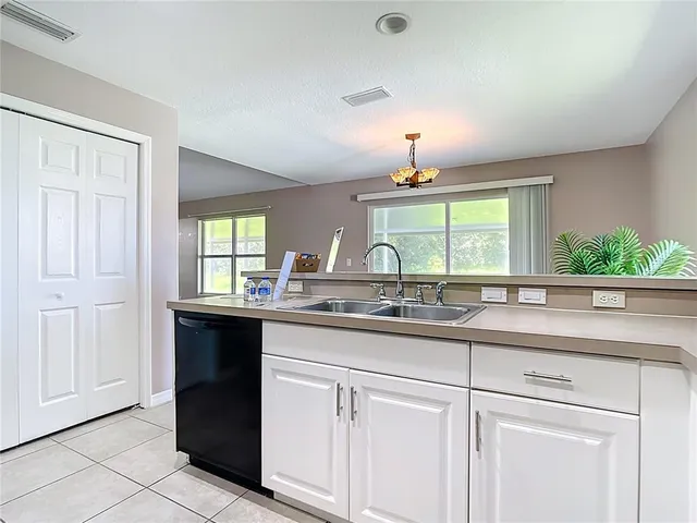 a spacious bathroom with double sink and a large mirror