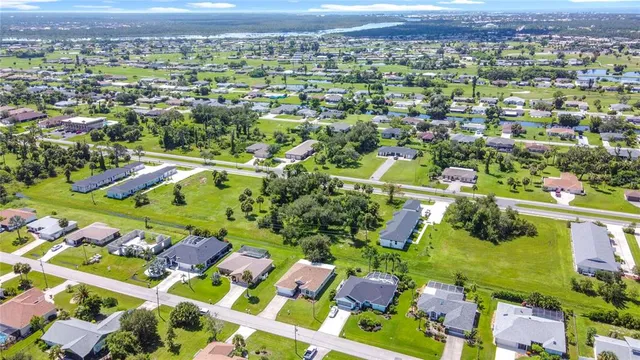 an aerial view of a houses with a swimming pool