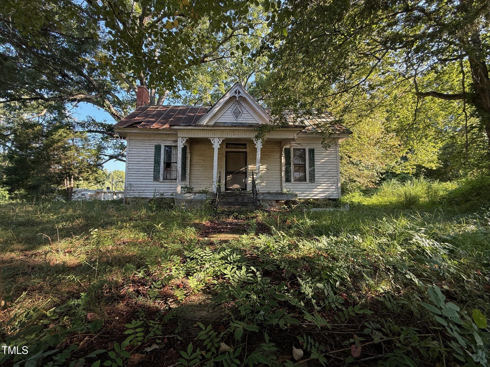 4079 Buckhorn Road Bullock, NC 27507 - Photo 5 of 11 a front view of a house with a garden