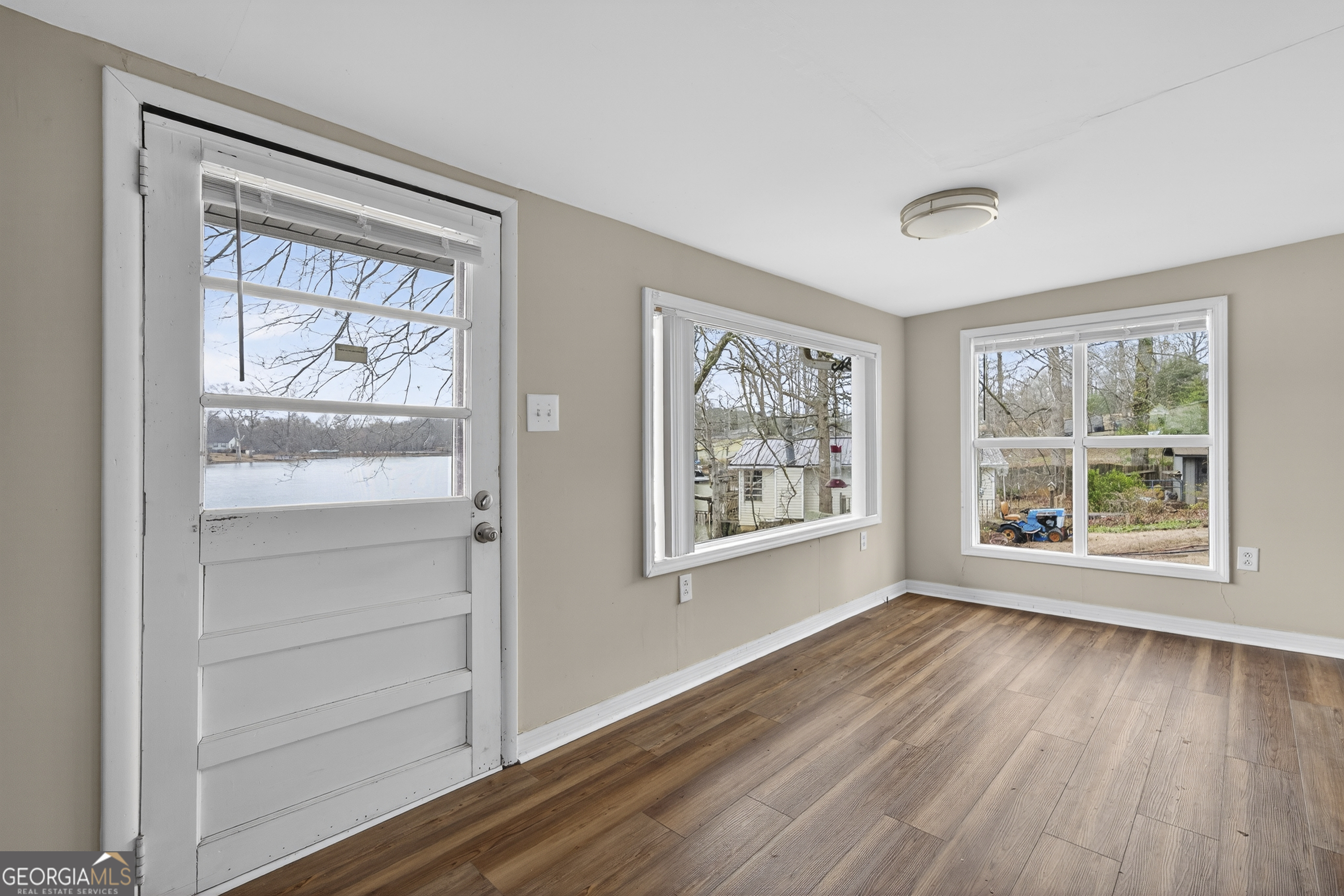 126 Elizabeth Circle Jackson, GA 30233 - Photo 11 of 41 a view of an empty room with a window and wooden floor