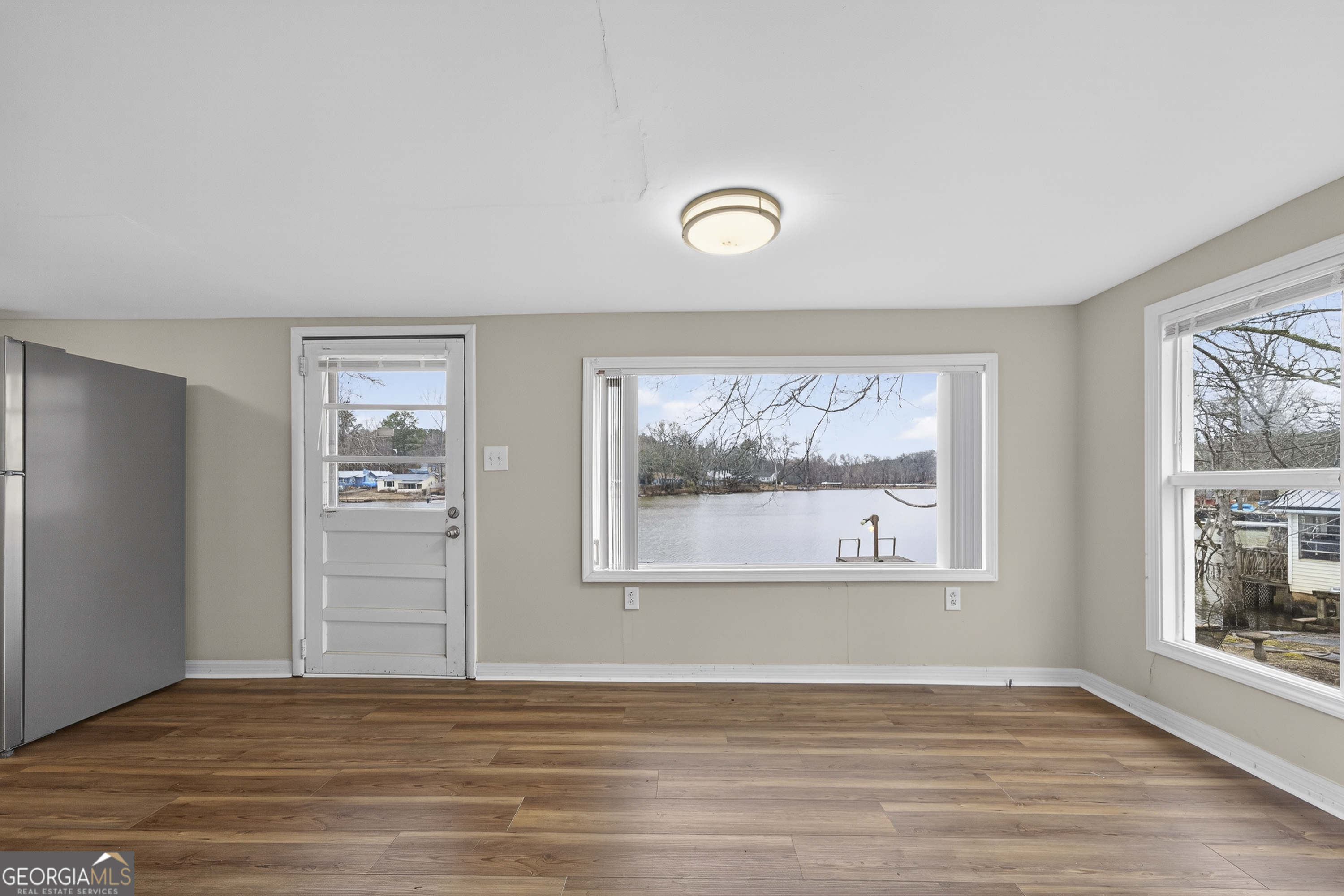 126 Elizabeth Circle Jackson, GA 30233 - Photo 16 of 41 an empty room with wooden floor and windows