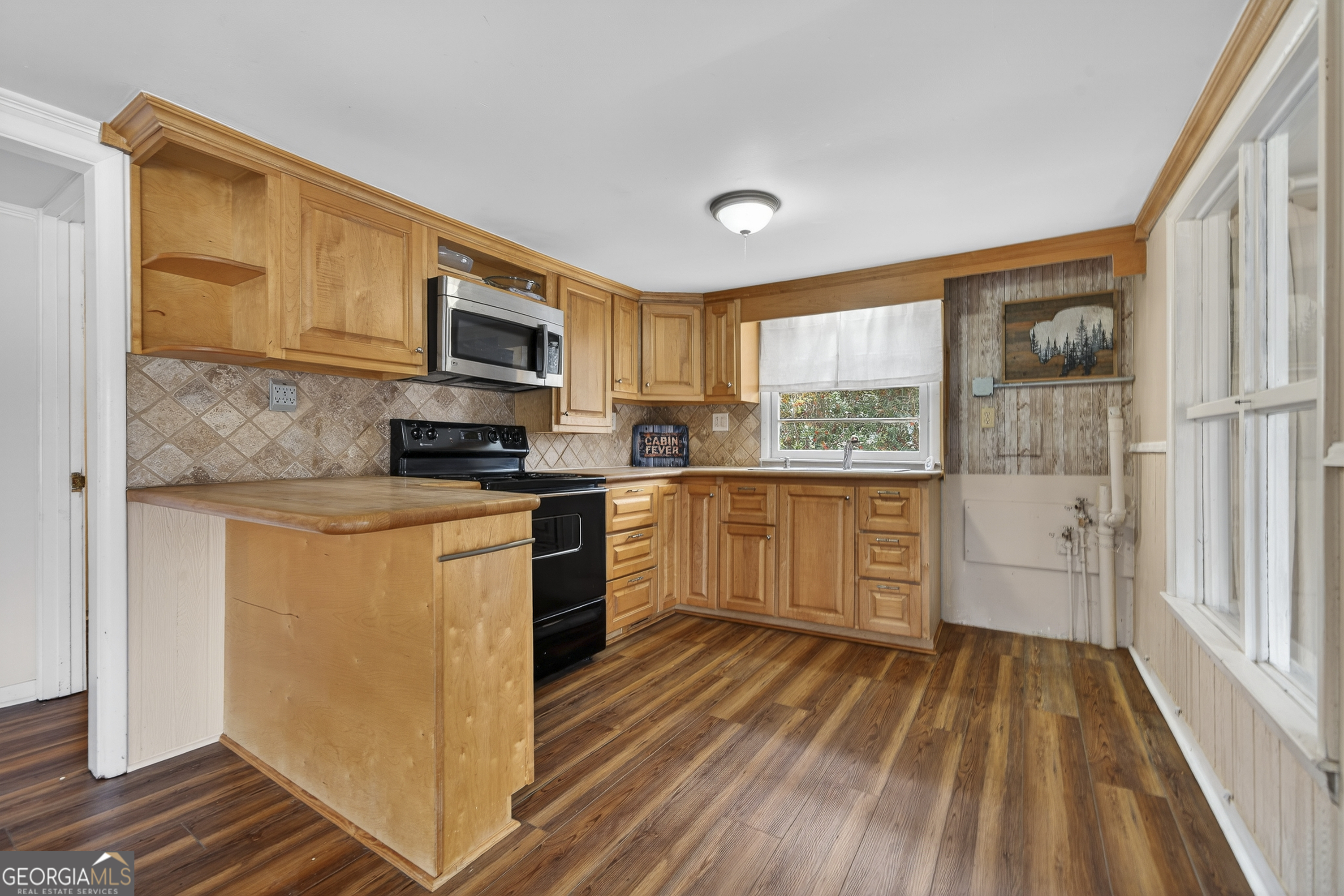 126 Elizabeth Circle Jackson, GA 30233 - Photo 6 of 41 a kitchen with stainless steel appliances granite countertop a stove a sink and a refrigerator