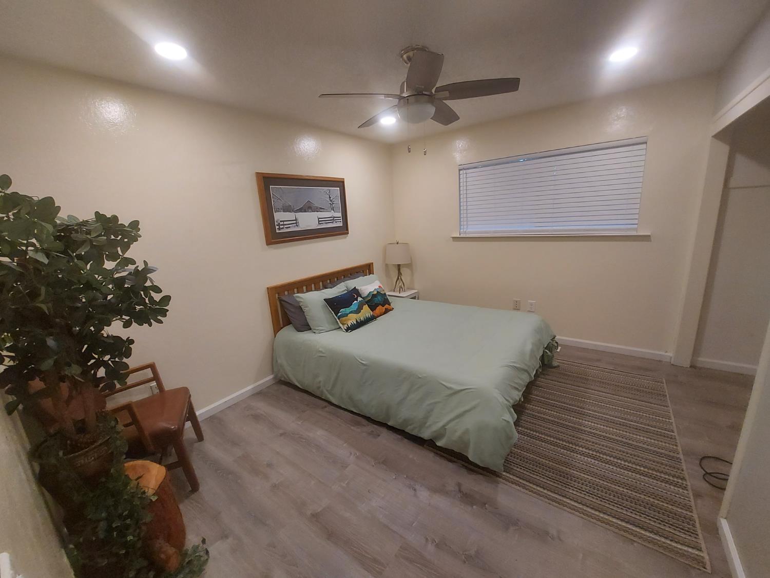 489 Alpine Drive Colfax, CA 95713 - Photo 11 of 46 a bedroom with a bed and a potted plant
