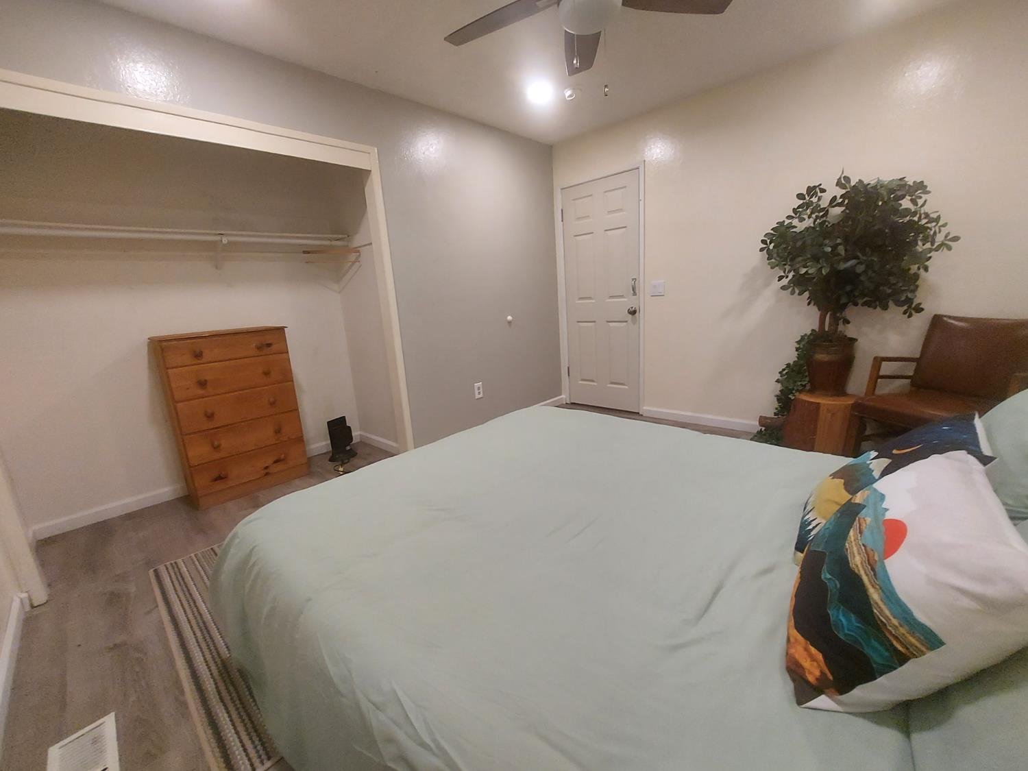 489 Alpine Drive Colfax, CA 95713 - Photo 13 of 46 a bedroom with a bed and a potted plant