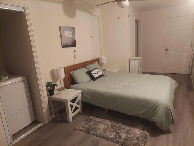 a bedroom with a bed and a couch