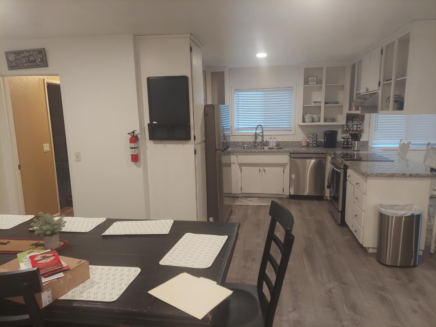 489 Alpine Drive Colfax, CA 95713 - Photo 6 of 46 a kitchen with stainless steel appliances granite countertop a refrigerator and a stove top oven