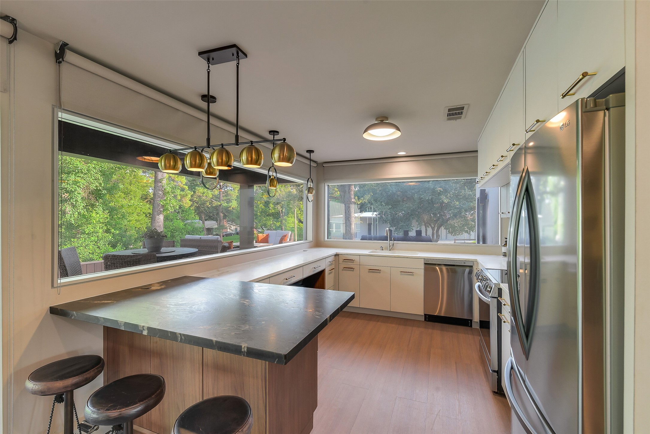 0 Camilla Lake Road Coldspring, TX 77331 - Photo 11 of 50 Brick House: A generous kitchen island adds seating and workspace to this highly functional kitchen, complimented by extensive cabinetry, specialty lighting and panoramic views of the amazing back landscaped area!