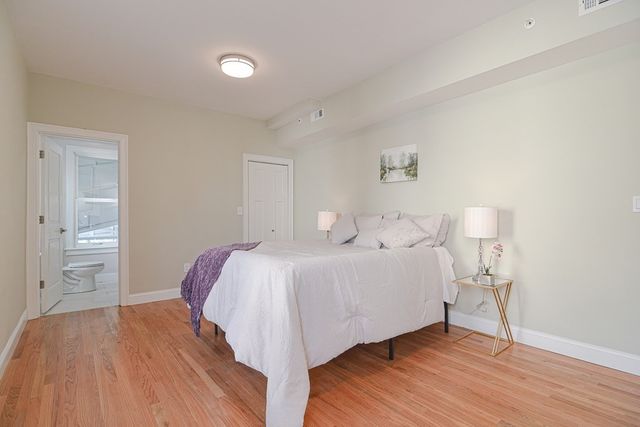 a bedroom with a bed and a lamp