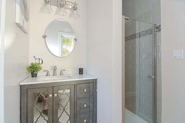 a bathroom with a sink vanity and a mirror