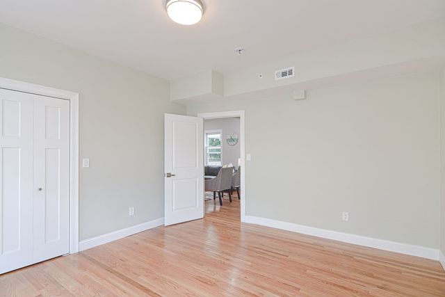 a view of a room with wooden floor and a window