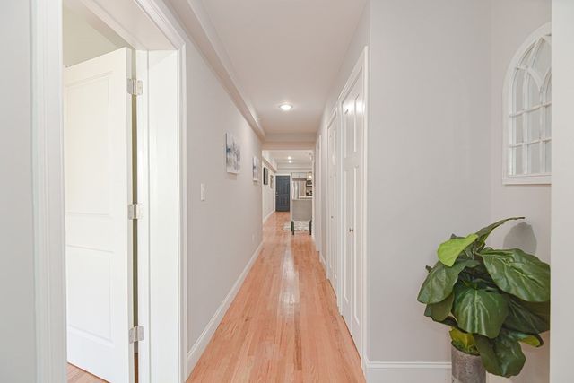 a view of hallway with wooden floor