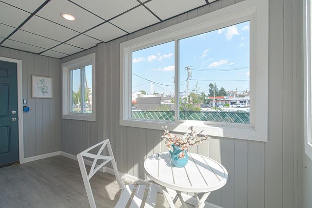 a dining room with furniture a chandelier and wooden floor