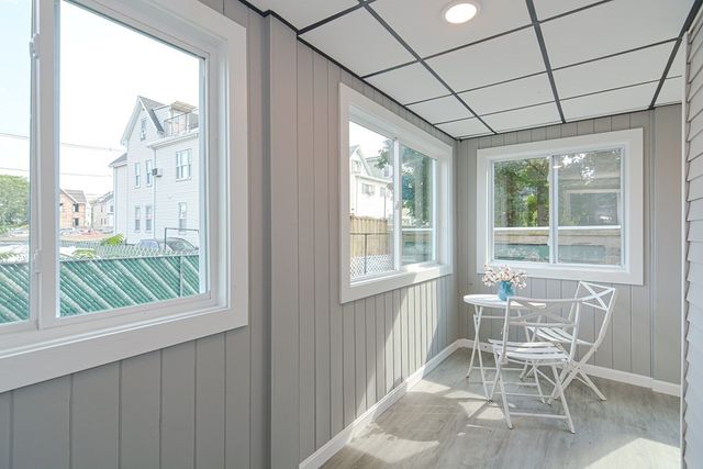 a dining room with wooden floor and a window