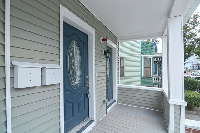 a view of a porch with wooden floor and stairs
