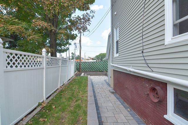 a backyard of a house with white floor and fence