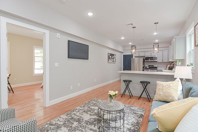 a open kitchen with stainless steel appliances granite countertop a sink and a refrigerator