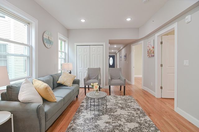 a living room with furniture and a rug